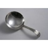 A GEORGE III CADDY SPOON with a bright-cut stem, plain round bowl  vacant cartouche, by Richard