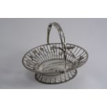 A LATE VICTORIAN SWING HANDLED OVAL BONBON BASKET with wirework sides & applied ears of wheat &