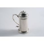 A GEORGE II PROVINCIAL KITCHEN PEPPER cylindrical with a scroll handle, by Isaac Cookson,