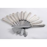 A MATCHED SET OF TWELVE GEORGE IV TABLE KNIVES Thread & Shell pattern, crested (steel blades) by two