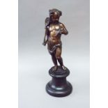 A BRONZE FIGURE of an infant fisherman, on a black marble socle, figure 13ins. (33cms.) high