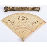 A CHINESE IVORY FAN guards & sticks with gold lacquered decoration, sticks partly brise and with