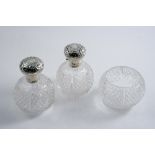 A PAIR OF EDWARDIAN MOUNTED CUT-GLASS TOILET WATER BOTTLES of globular form with hinged covers &