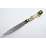 A GEORGE III SILVERGILT MOUNTED KNIFE the handle cast as a putto carrying a basket of grapes on