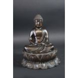 A BRONZE SEATED BUDDHA on a lotus pedestal, 9 1/2ins. (24cms.) high
