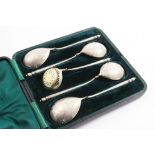 A VICTORIAN CASED SET OF FOUR PARCELGILT FRUIT SERVING SPOONS & A MATCHING SUGAR SIFTER LADLE in the