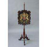 A VICTORIAN ROSEWOOD JACOBETHAN POLESCREEN the banner with a needlework Royal Arms panel, banner