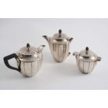 AN EARLY 20TH CENTURY FRENCH SMALL TEA POT, HOT MILK JUG & COVERED SUGAR BOWL with vertically fluted