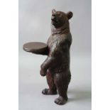 A BAVARIAN WOOD BEAR its coat naturalistically carved, glass set eyes, 39 3/4ins. (101cms.) high