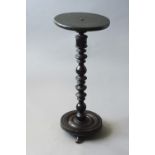 THE STEM AND BASE OF A 17TH CENTURY LIGNUM VITAE CANDLESTAND the stem boldly turned, 28 1/2ins. (