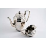 AN EARLY 20TH CENTURY GERMAN TEN-SIDED COFFEE POT & matching milk jug with angular handles,
