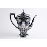 AN EARLY 20TH CENTURY AMERICAN ART NOUVEAU GLAZED PORCELAIN COFFEE POT, dark blue with overlay