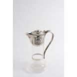 A VICTORIAN MOUNTED CUT-GLASS CLARET JUG with a star-cut base, the mounted embossed with fruiting