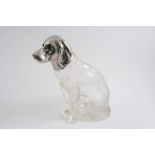 A MODERN NOVELTY PLATED MOUNTED CLEAR GLASS DECANTER in the form of a seated gun dog with textured