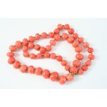 A SINGLE ROW GRADUATED CORAL BEAD NECKLACE 58cm. long, 95 grams.