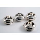 A MATCHED SET OF FOUR QUEEN ANNE SQUAT CIRCULAR TRENCHER SALTS, two initialled "M" underneath, by