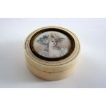 A 19TH CENTURY EARLY CIRCULAR IVORY BOX & COVER inset with the portrait miniature of a girl in a