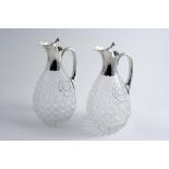 A PAIR OF MOUNTED CUT-GLASS CLARET JUGS with plain mounts, loop handles & pear-shaped bodies, by