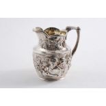 A VICTORIAN SQUAT CREAM JUG decorated in relief with figures drinking & taking snuff against a