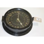 A US NAVY CLOCK. A black faced 24 hour US Navy clock, in working order. 7.1/2" dial with Made by