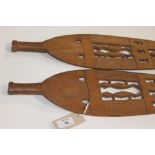 CARVED WOODEN SPEAR BLADES. Southern hemisphere carved wooden paddle blades, with voided design of