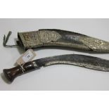 A KUKRI. A Kukri with silvered mounts and 12" blade, the tip has a chip approx 1/4" long. Wooden