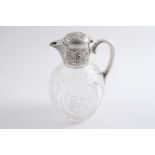 A LATE VICTORIAN MOUNTED CUT-GLASS CLARET JUG with a chased mount & an oviform body, by J.T. Heath &