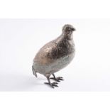 A CONTINENTAL NOVELTY TABLE DECORATION modelled as a game bird, perhaps a quail or partridge with