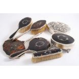 TWO MOUNTED TORTOISESHELL HAND MIRRORS three brushes, and an oval jewel box, all with inlaid