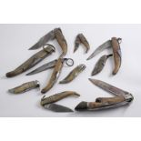 TEN VARIOUS SPANISH STEEL POCKET KNIVES  (six with etched blades), mainly with horn sides;  the