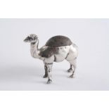 AN EDWARDIAN NOVELTY PIN CUSHION in the form of a standing camel, stuffed & loaded, by Adie &