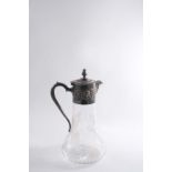 A MODERN MOUNTED CUT-GLASS CLARET JUG with a decorative mount, the baluster body cut with fruiting