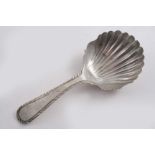 A GEORGE III FEATHER-EDGE CADDY SPOON with a shaped & fluted bowl, initialled "AW" on the back of