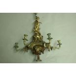 A VICTORIAN BRASS CHANDELIER with hexagonal platform with six candle branches, the stem encircled by