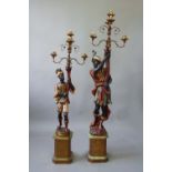 TWO BLACKAMOOR TORCHERES each figure with elaborately painted robes, holding aloft a cornucopia