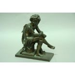 A FRENCH BRONZE FIGURE of a seated Bacchanal with grapes in his hair, a tambourine resting on a