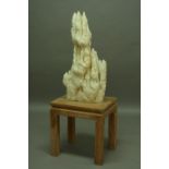 A STALAGMITE the white crystalline stone of pointed form height 34.5" (88 cms) mounted on an oak