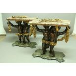 A PAIR OF ITALIAN CONSOLE TABLES each in the form of two putti holding leafy swags, painted bronze