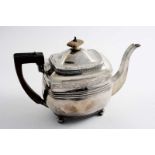 A GEORGE III TEA POT of rounded oblong form, on ball feet, with border engraving by Peter &