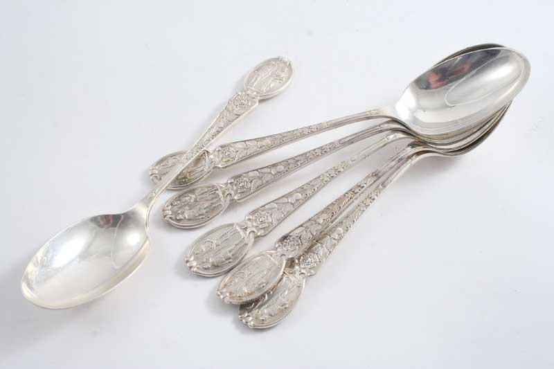 SIX VARIOUS DECORATIVE TABLE SPOONS with the badge of the Artist Rifles on the terminal, five of