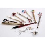 FOUR BONE LACE BOBBINS Three wooden lace bobbins, a gold-plated fountain pen, etc.;  the pen 5.