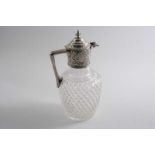 A LATE VICTORIAN MOUNTED CUT GLASS CLARET JUG with an angular handle, knop finial & chased mount