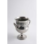 REGIMENTAL INTEREST: A George III two-handled cup with part-fluting & a frieze of fruiting vines