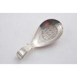 A GEORGE III CADDY SPOON with a drop-shaped bowl, "pricked" engraving, a vacant cartouche &