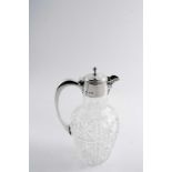 AN EDWARDIAN MOUNTED CUT-GLASS CLARET JUG with a c-shaped handle & knop finial, maker's mark "M&CO",