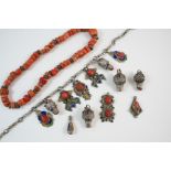 AN INDIAN SILVER, CORAL AND ENAMEL NECKLACE together with six similar pendants, and a coral