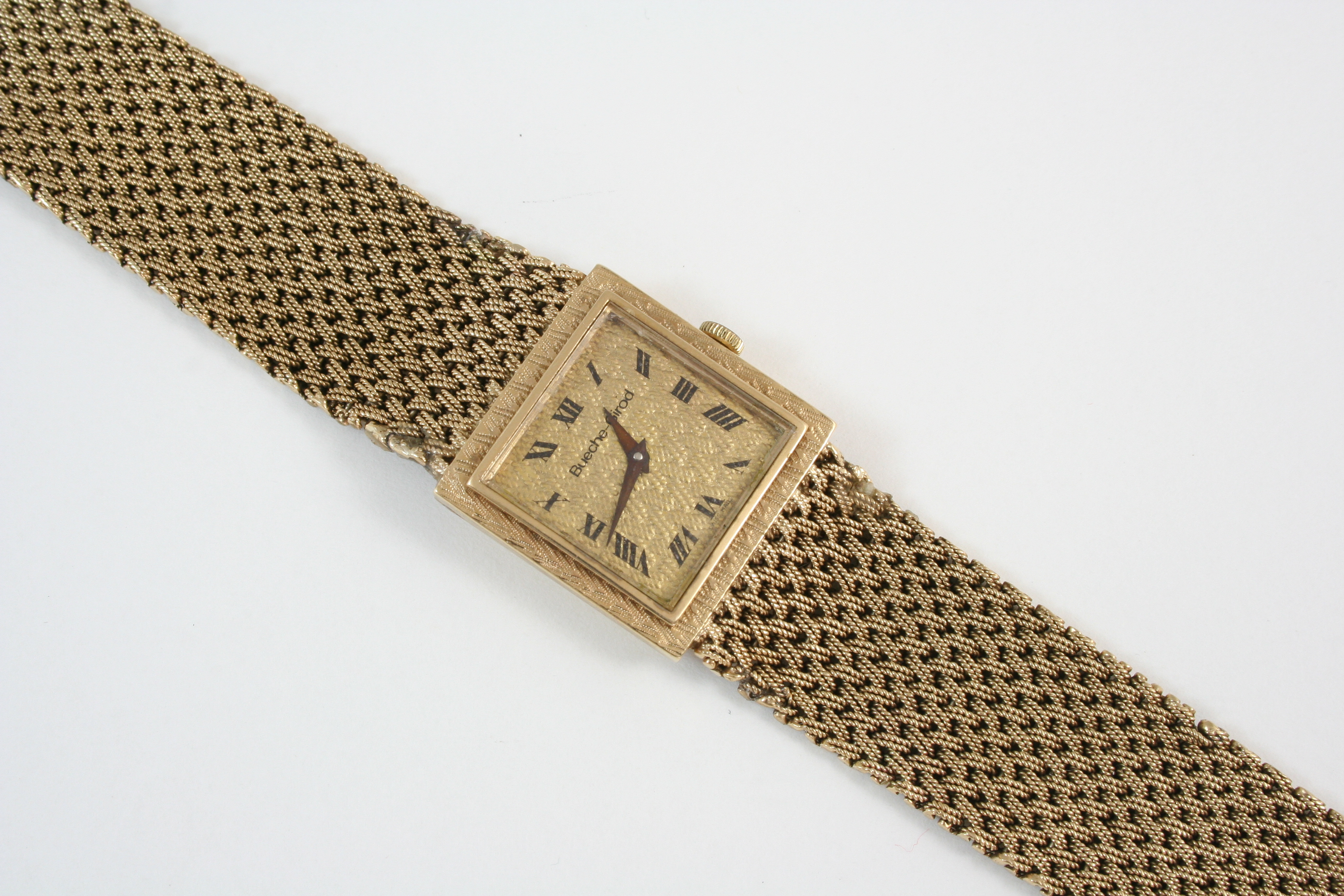 A GENTLEMAN'S GOLD WRISTWATCH BY BUECHE-GIROD the signed gold granulated dial with Roman numerals,