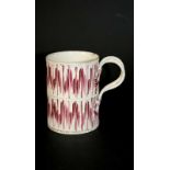 CREAMWARE TANKARD with a ridged body and painted with splashes of red, with a twisted double strap