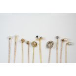 NINE ASSORTED STICK PINS including one set with an enamel duck and a small pearl, one formed as a