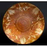 ALAN CAIGER-SMITH - LARGE DISH an exhibition dish with a floral design and lustre glaze. Painted